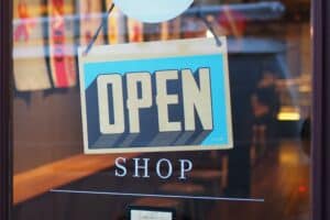 A close-up image of an open shop sign as the result of incorporating a business.