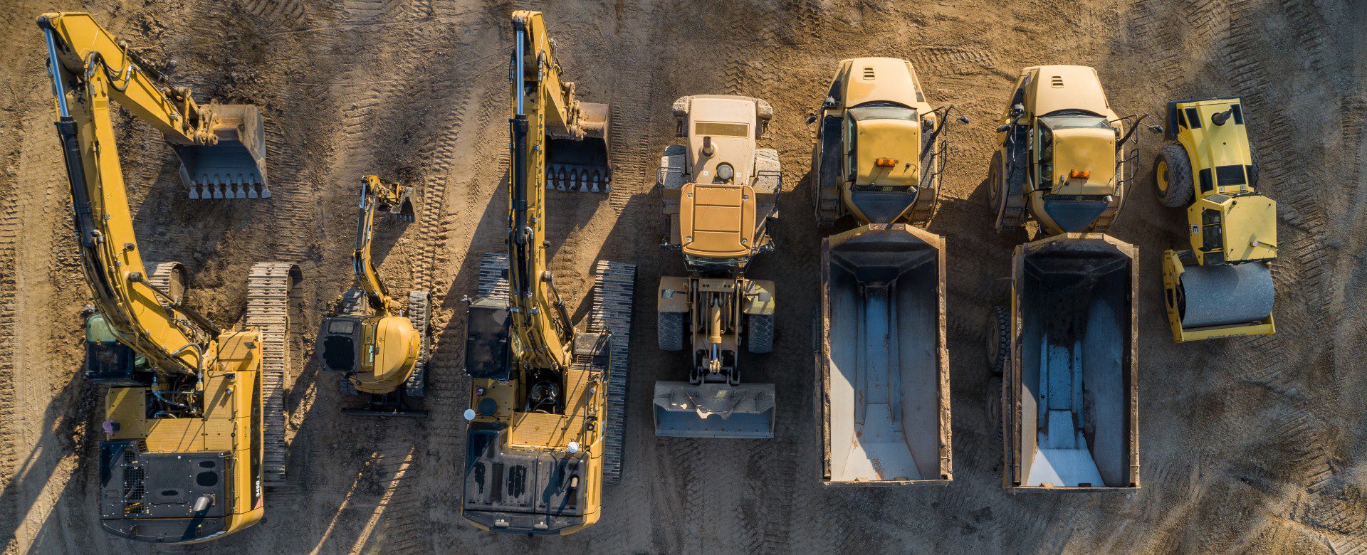 How Equipment Loan Benefits the Construction Industry, Drone shot of trucks lined up