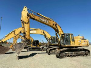 Several large yellow excavators sit atop the dirt to describe an article about how heavy construction equipment financing can benefit construction businesses.